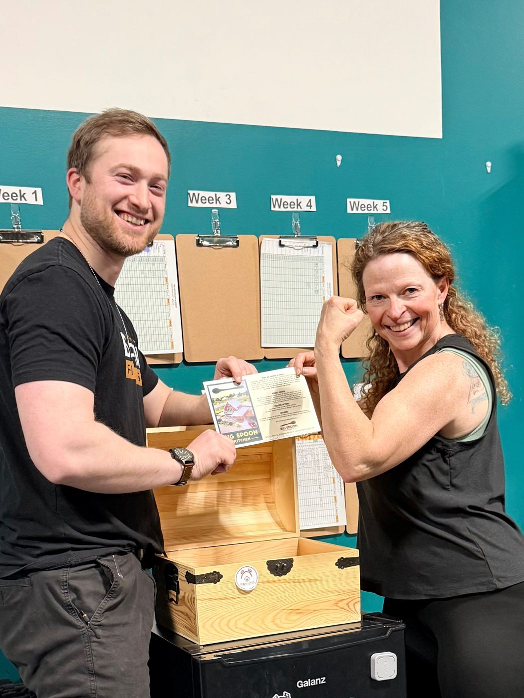 Spring challenge winner flexing beside her Shapesmith and the prize chest