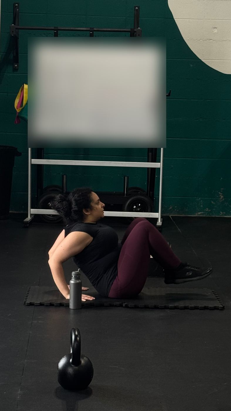 Adventurer doing core work on the gym floor