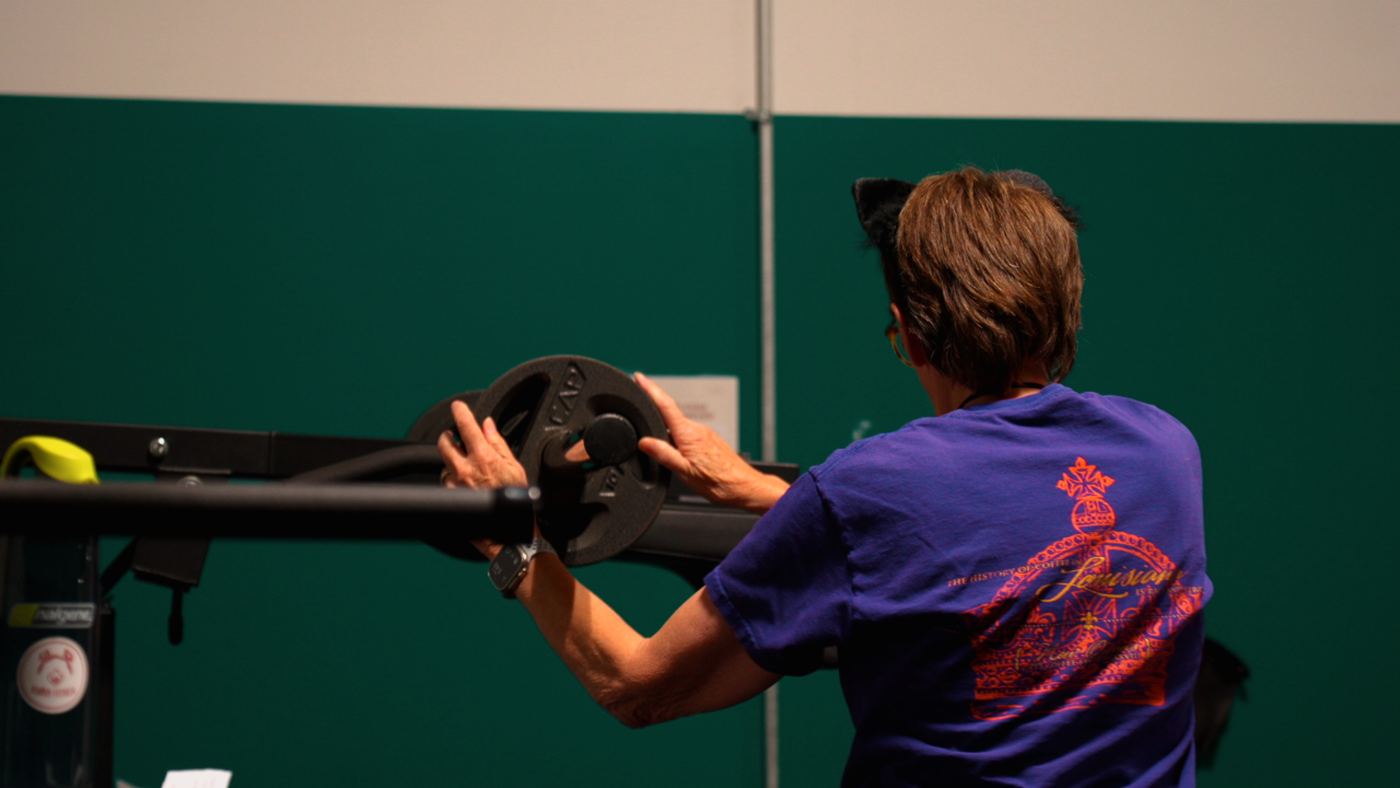 Adventurer loading plates onto a barbell