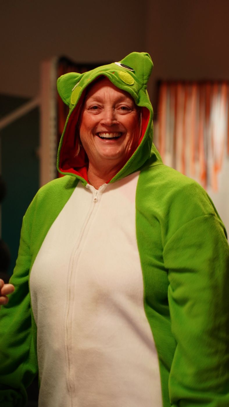 A smiling Adventurer in a frog costume