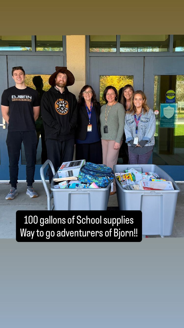 Bjorn Fitness Shapesmiths and local school staff with bins of donated school supplies