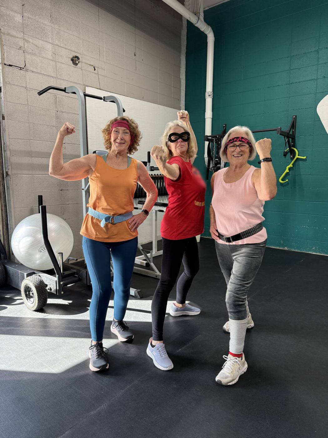 Three Adventurers in their sixties flexing on the floor of the Forge