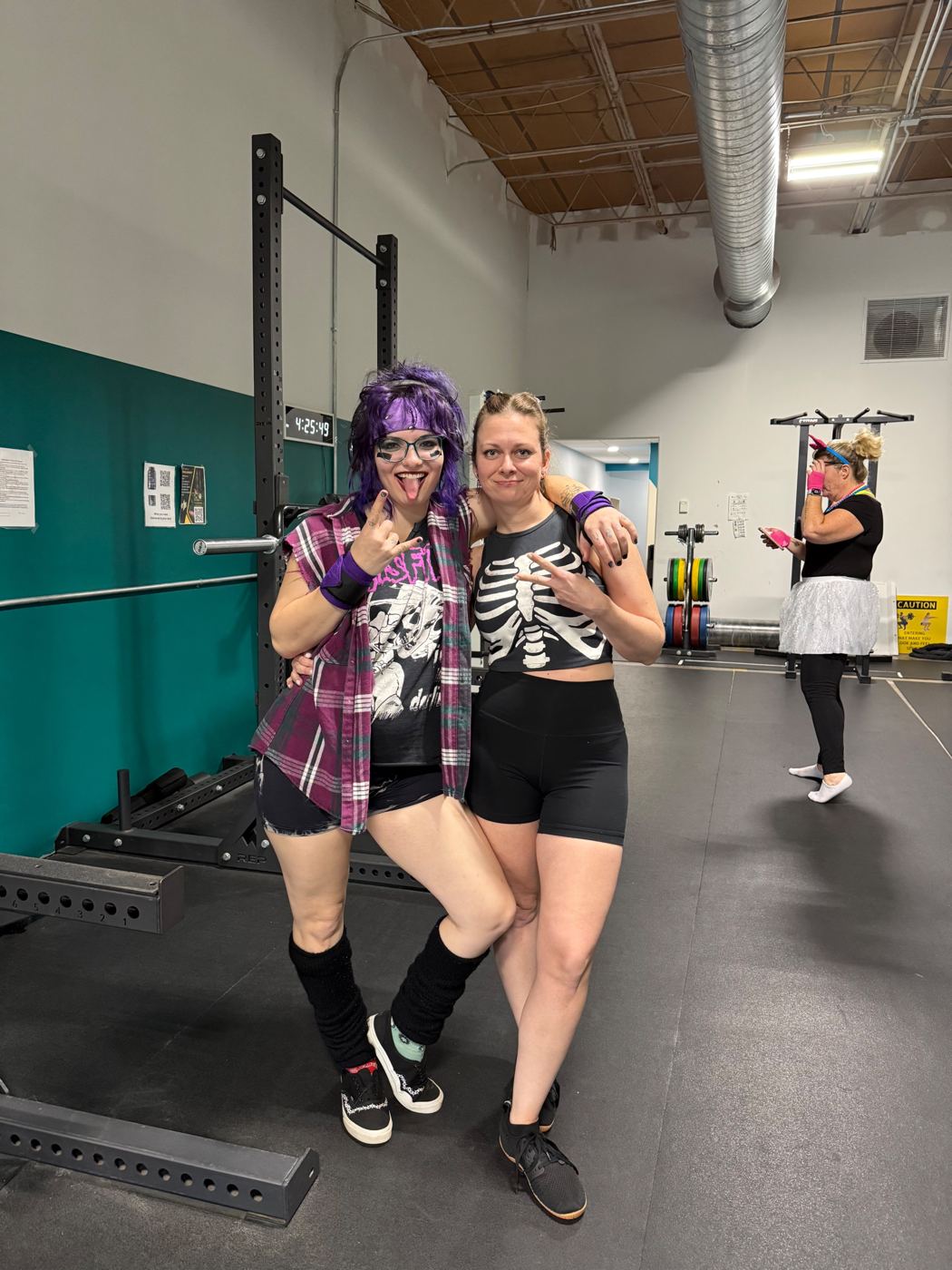 Two Adventurers in punk costumes throwing rock signs
